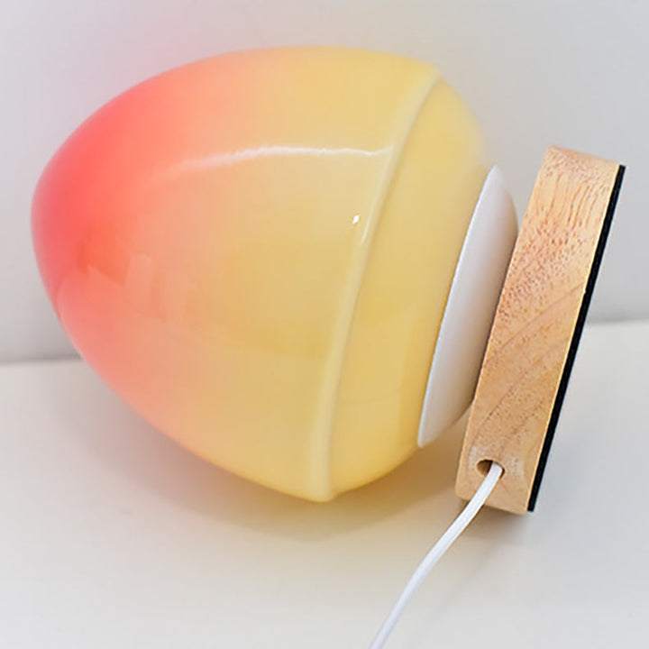 MöniGlow – Peach-Colored LED Table Lamp with Wooden Base and USB Charging Function